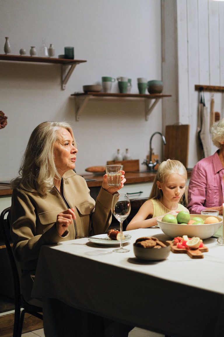 A family enjoying a dinner together indoors as they engage in conversation.